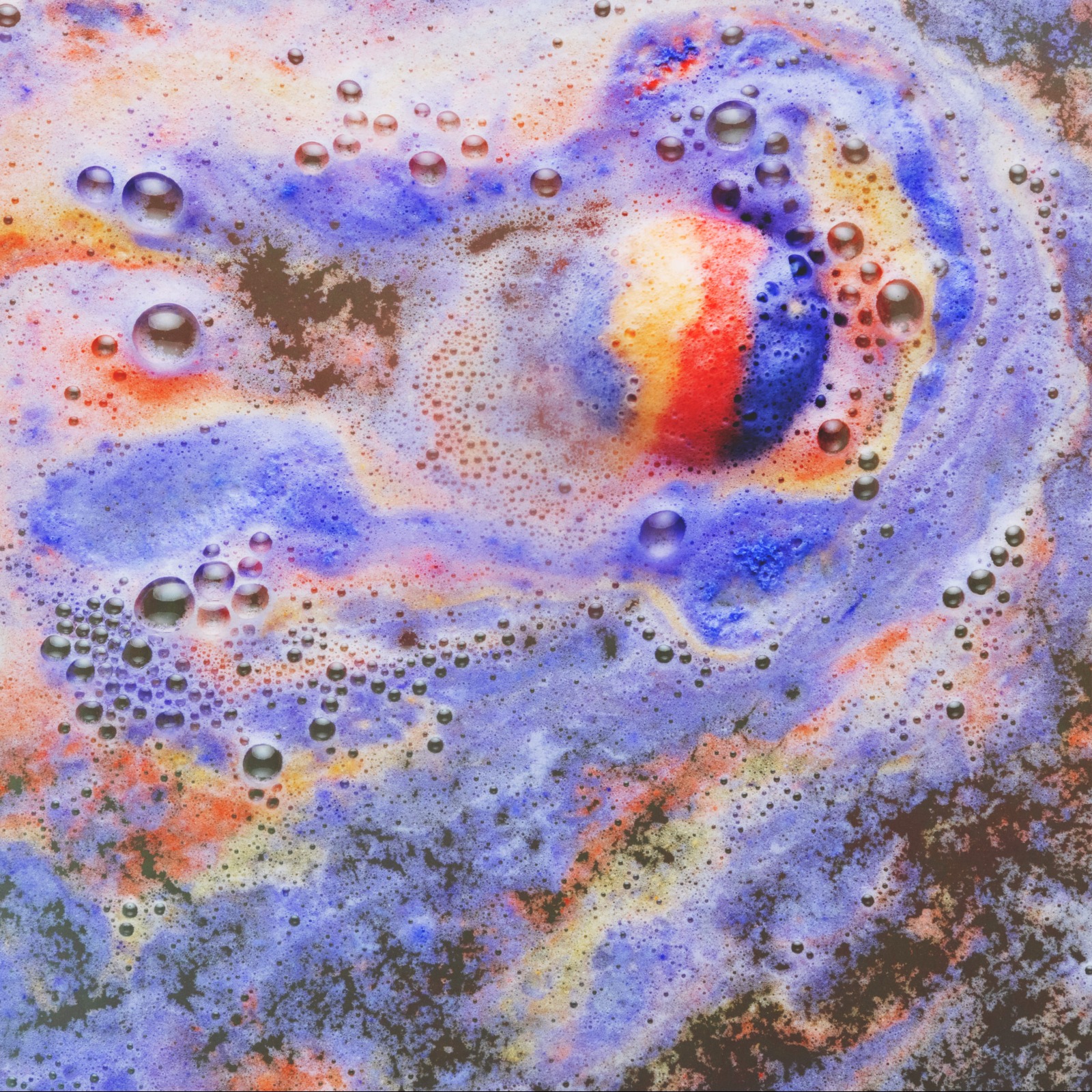 Imagem exemplificando como funciona um flotador multiuso. Nela há espuma de diferentes cores em cima de um líquido.